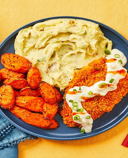 Crispy Frank’s RedHot®-Spiced Chicken with Blue Cheese Sauce, Scallion Mashed Potatoes & Carrots
