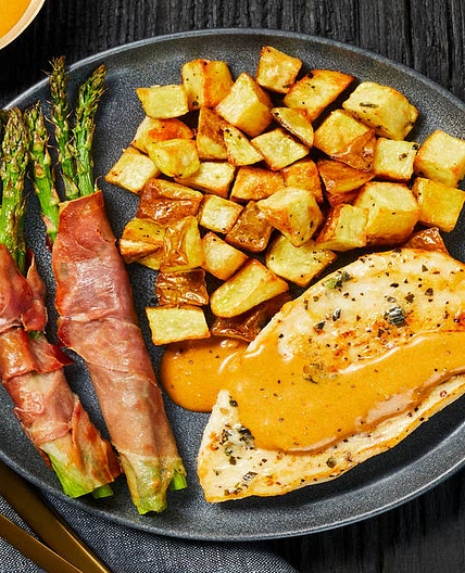 Buttery Garlic-Herb Chicken with Prosciutto-Wrapped Asparagus & Herbed Potatoes