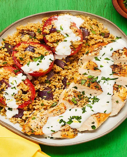 Za’atar-Spiced Chicken with Bulgur-Stuffed Roasted Tomatoes & Lemon Garlic Yogurt Sauce