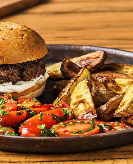 Herby Beef Burgers with Potato Wedges and Tomato Salad
