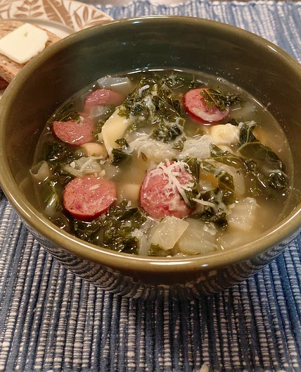 Cheese tortellini soup with cannellini, kielbasa, and kale.