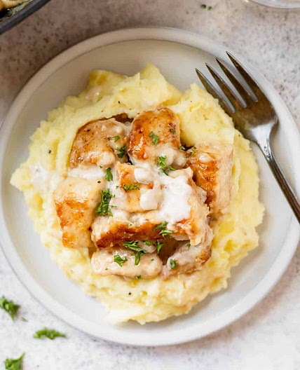 Creamy Garlic Chicken Bites Over Mashed Potatoes
