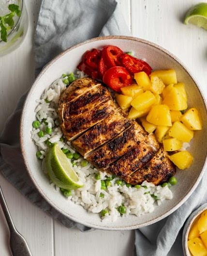 Jerk chicken with creamy coconut rice, peas and mango