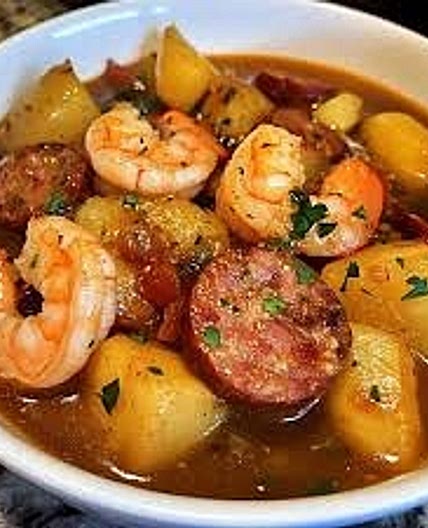 Smothered potatoes with shrimp, chicken and sausage