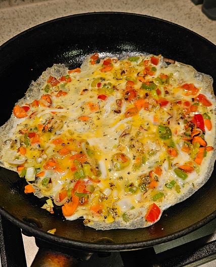 Omelette with carrot, celery, and capsicum