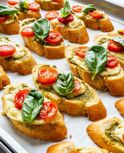 Pesto Crostini with Cheese and Tomatoes