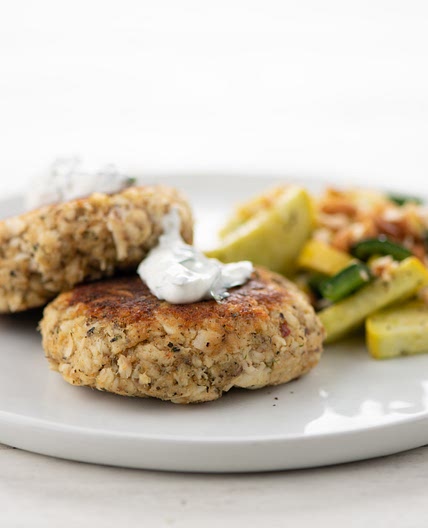 Spicy Argentinian Fish Cakes with cilantro crema, roasted poblanos, and summer squash