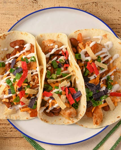 Chicken Chili Tacos with beans and sour cream
