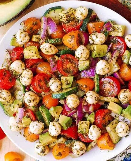 Tomato Cucumber Avocado Salad with Mozzarella and Basil Pesto