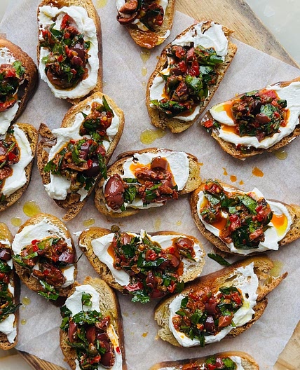 Puttanesca crostinis with whipped ricotta