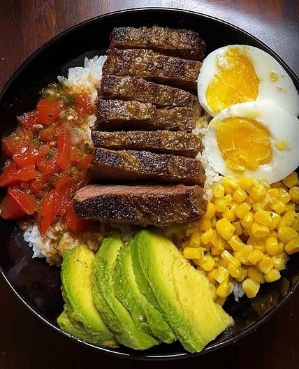 Juicy Garlic Butter Steak &amp; Rice Power Bowl with Avocado, Corn &amp; Fresh Salsa 🌽🍅 𝐈𝐧𝐠𝐫𝐞𝐝𝐢𝐞𝐧𝐭s 7 oz (200 g) boneless beef steak ½ cup cooked white rice ½ medium ripe avocado ½ cup sweet corn kernels 1 medium ripe tomato, diced 1 large egg