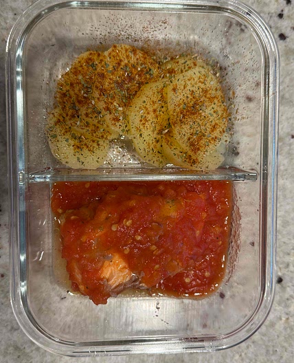 Troat in tomato sauce served with potatos.