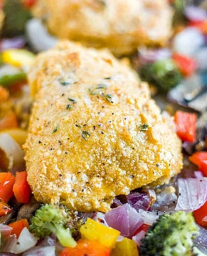 Crispy Almond-Crusted Chicken Thighs with Mediterranean Roasted Vegetables, Lemon-Herb Quinoa & Creamy Garlic Sauce