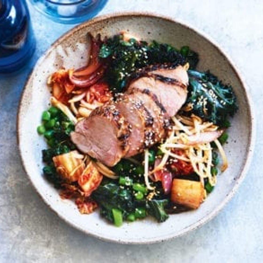 Roasted pork with warm kimchi and kale salad