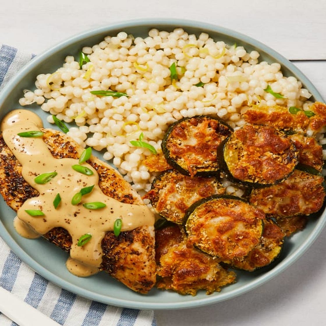 Creamy Lemon Butter Chicken with Mozzarella Zucchini Rounds & Scallion Couscous
