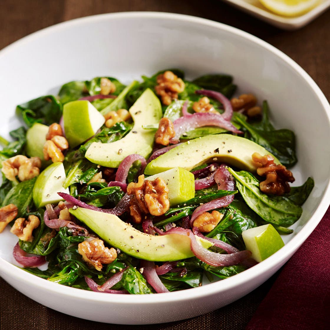 Wilted Spinach Salad with Grilled Onions, Walnuts, Avocado, and Apple | Oldways