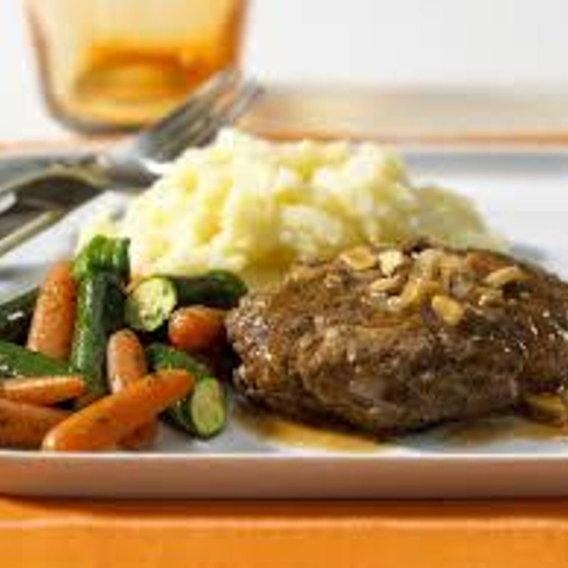 Meatball patties with mashed potato, roast carrots and brussels