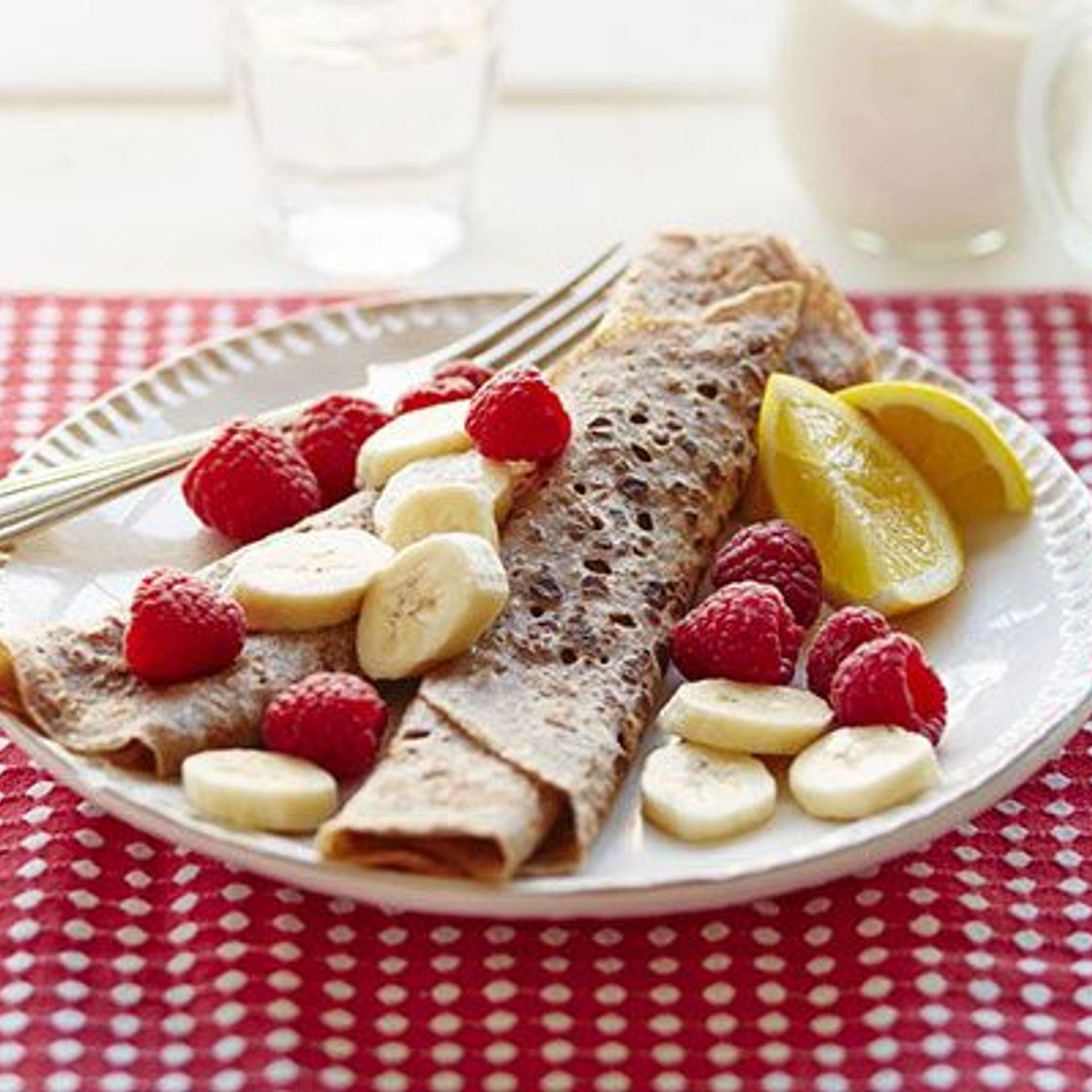 Cinnamon crêpes with nut butter, sliced banana & raspberries