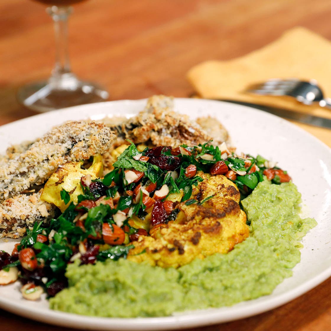 Curry Cauliflower Steak with Cranberry-Almond Gremolata, Pea Puree, and Portobello Mushroom Fries