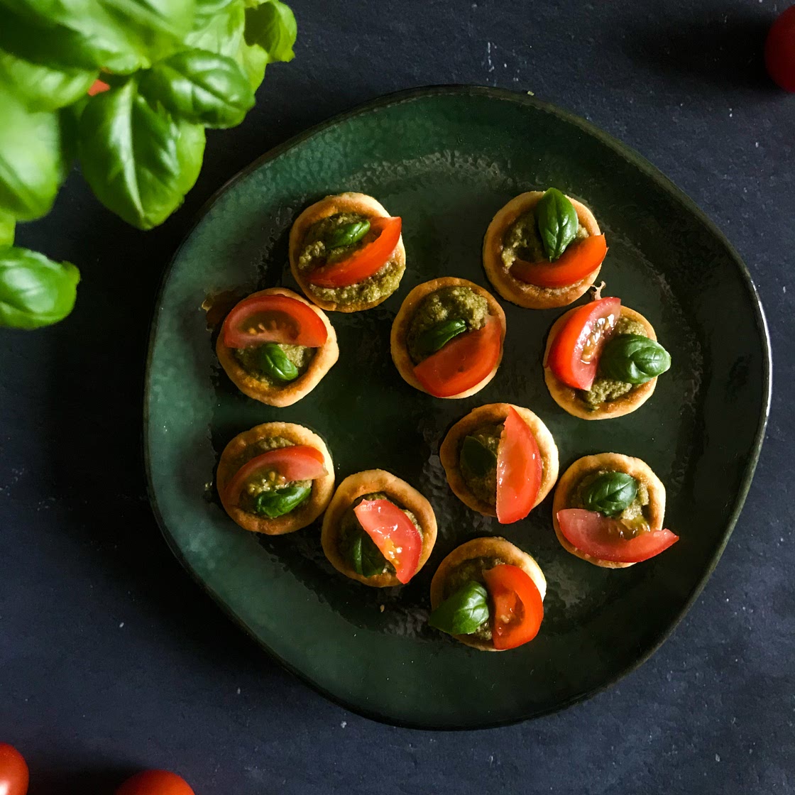 Crackers with pesto, cherry tomatoes & fresh basil