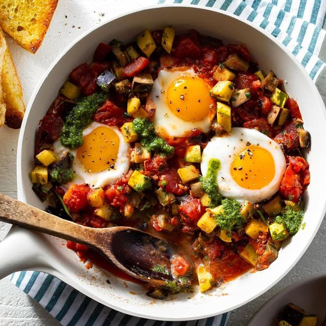 Spanish pisto con huevos with tomatoes, eggplant, and garlic bread