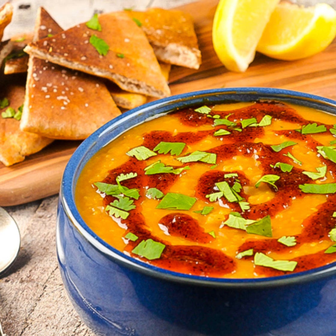 Red Lentil Soup with berbere oil, lemon, cilantro, and whole wheat pita