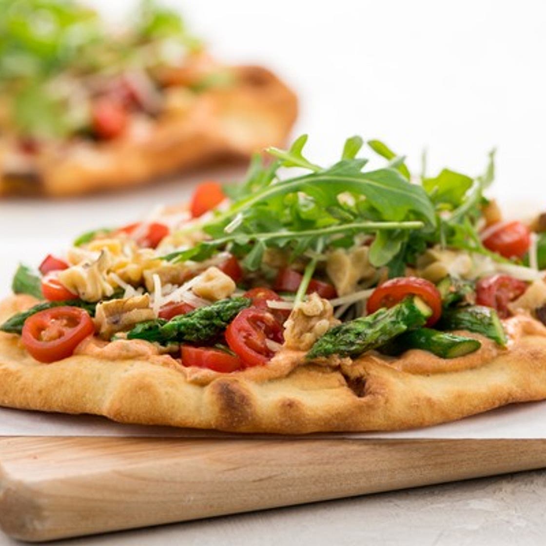 Asparagus & Tomato Flatbread with Roasted Red Pepper Crema with Asiago cheese and arugula
