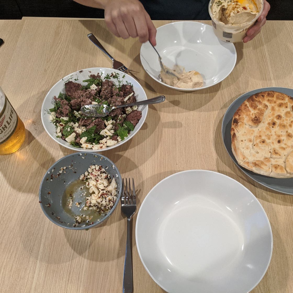 Seared lamb patty with marinated halloumi and herbs