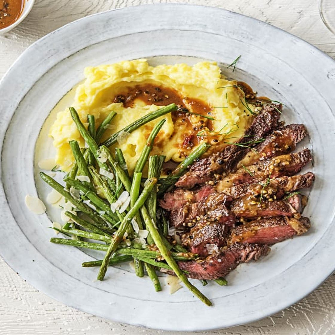 Peppered Rib-Eye Steak with Truffled Mashed Potatoes and Green Beans Amandine