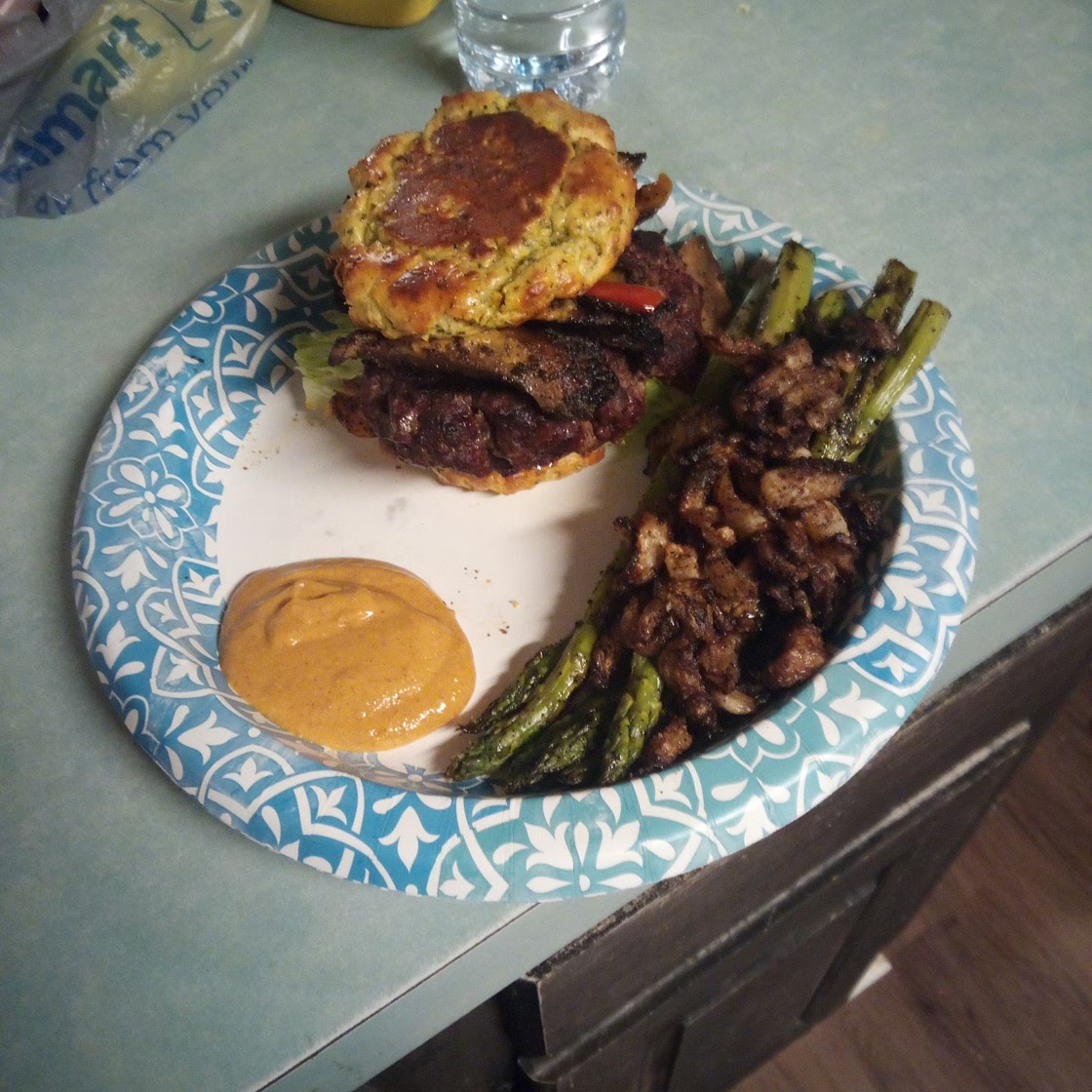 A Burger with a broccoli cheese bread