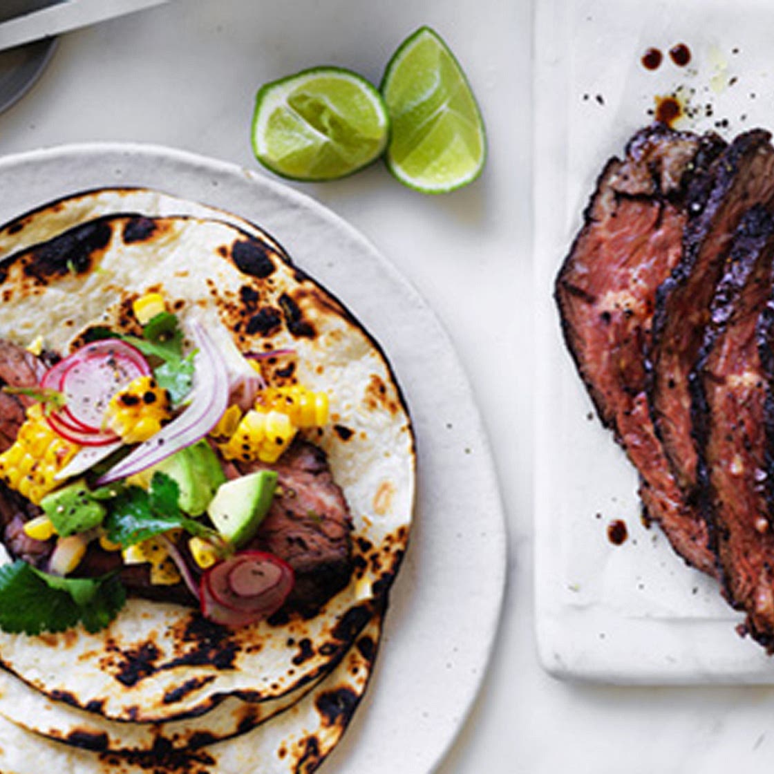 Flank steak tacos with corn, avocado and coriander