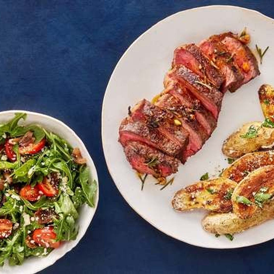 Pan-Seared Strip Steaks & Rosemary-Butter Sauce with Arugula Salad & Garlic-Parmesan Potatoes