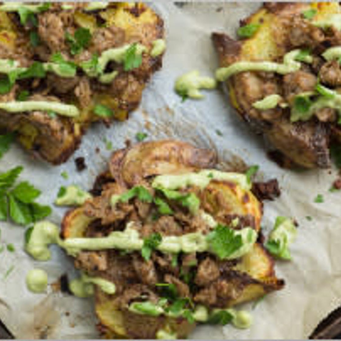Smashed potatoes with avocado aioli and sausage