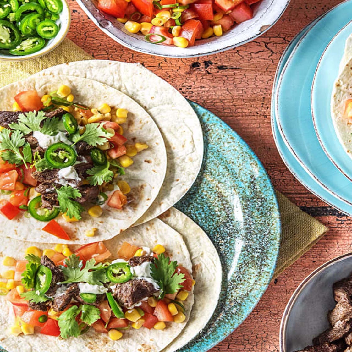 One-Pan Steak Fajitas With Tomato Corn Salsa, Cilantro, and Sour Cream