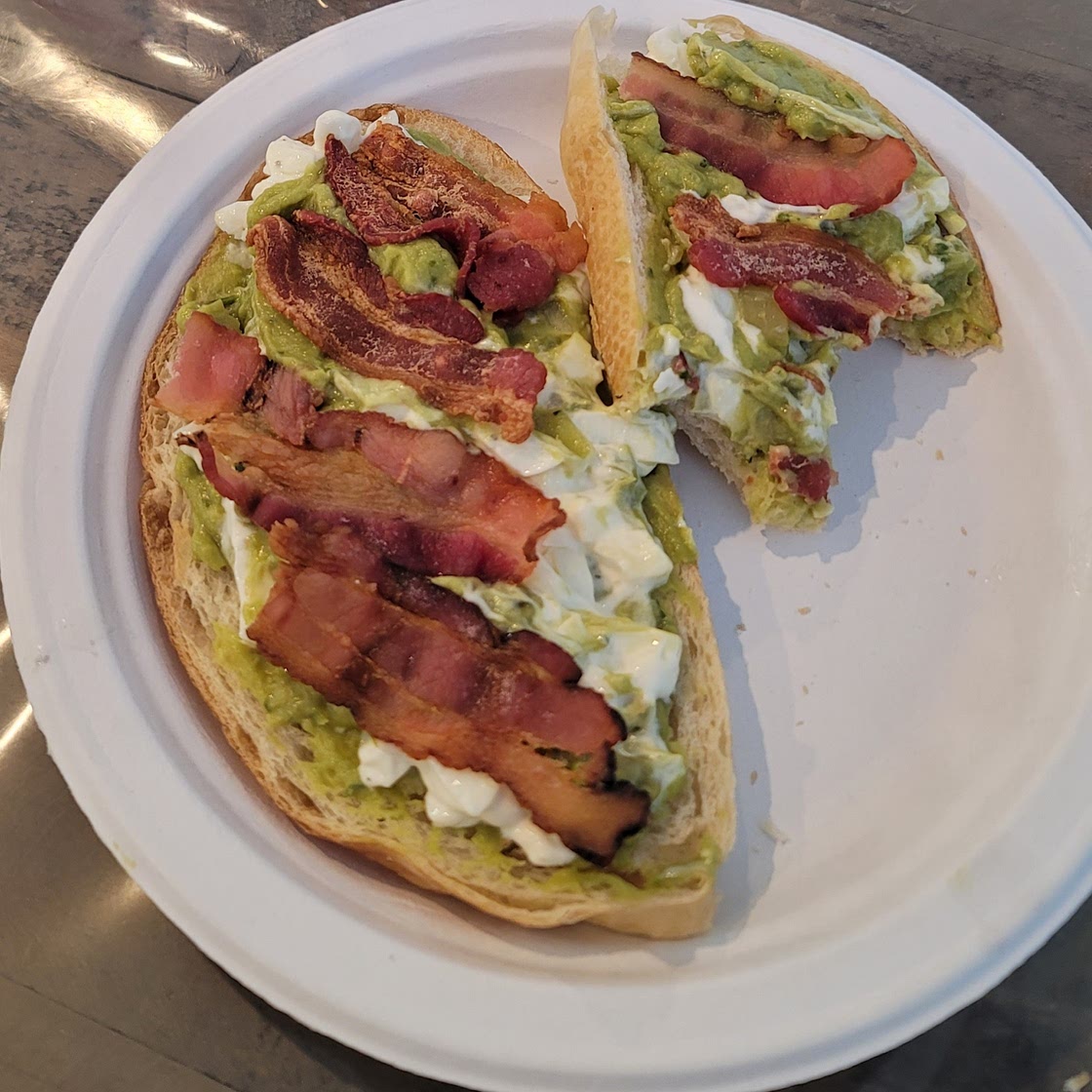 Sourdough toast with egg, guac, & bacon