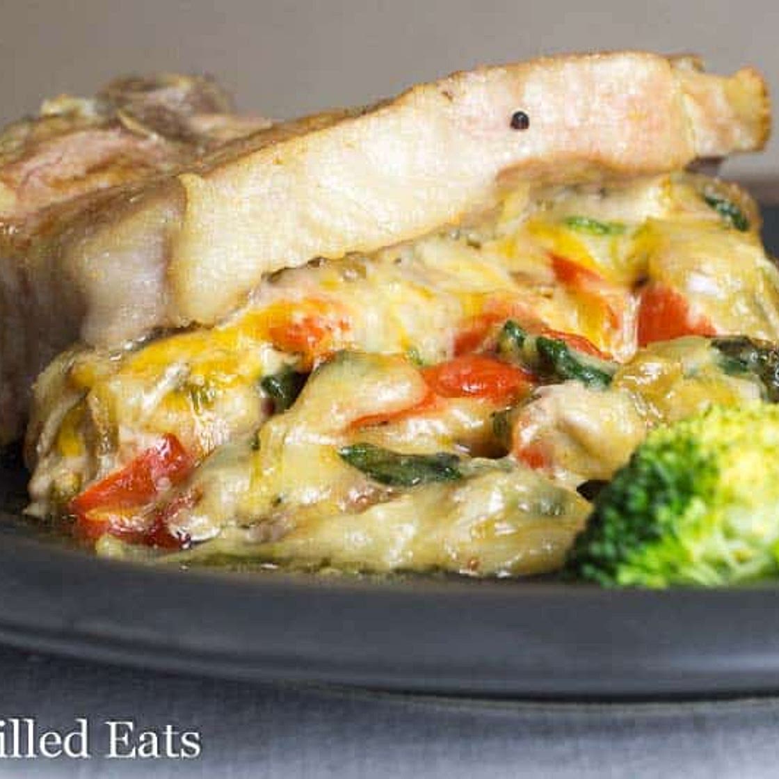 Cheesy Spinach Stuffed Pork Chops with Peppers & Onions