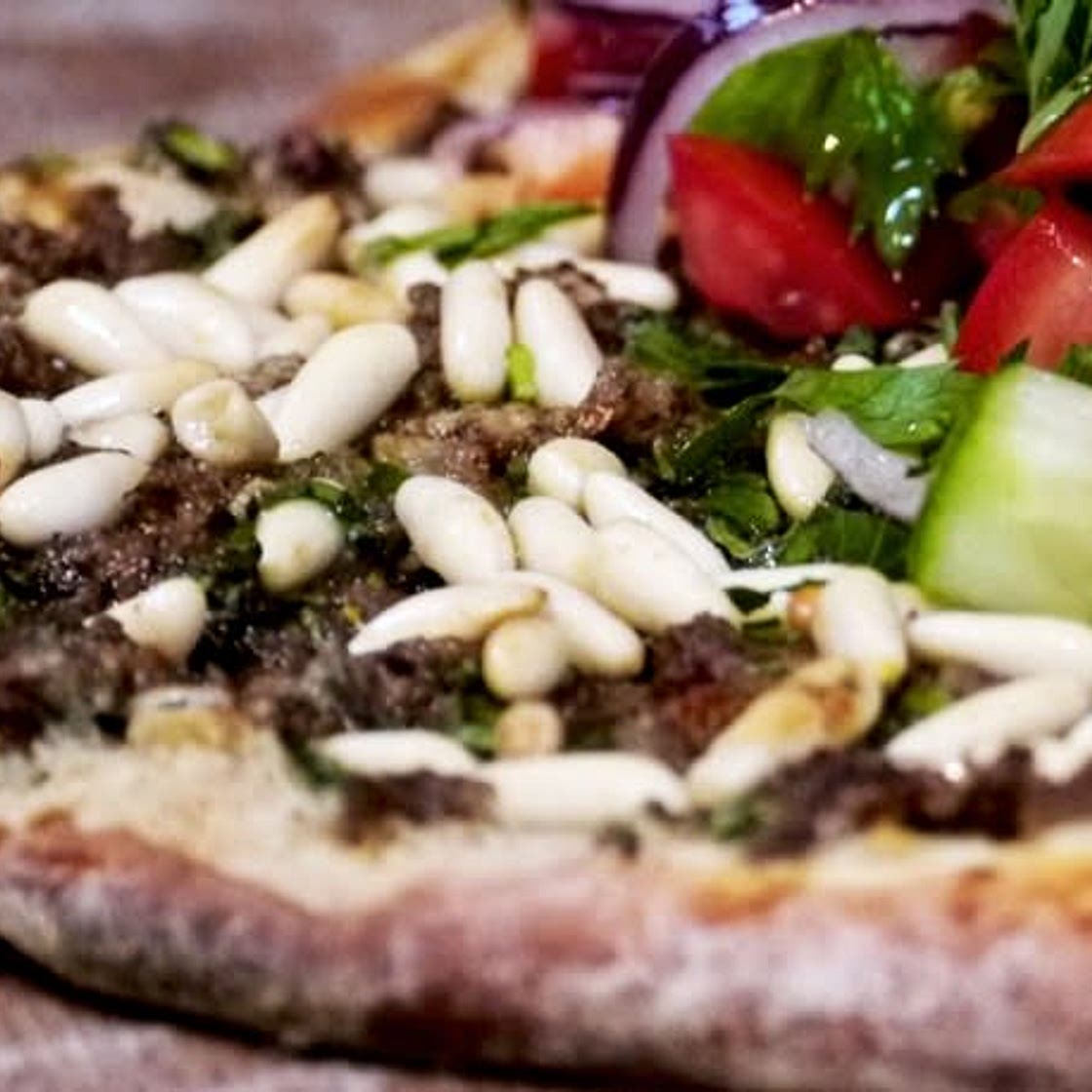 Lahmacun - Turkish pizza with spicy minced beef and salad topping