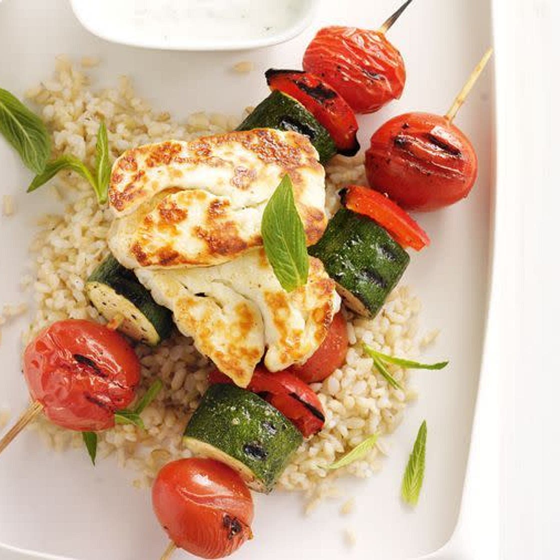 Vegetable kebabs with grilled haloumi, garlic yoghurt and lemon rice