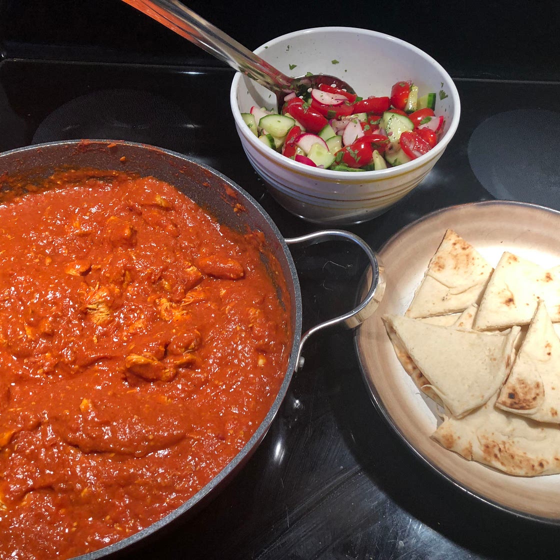 Butter Chicken with Rice and Naan served with Cucumber Salad