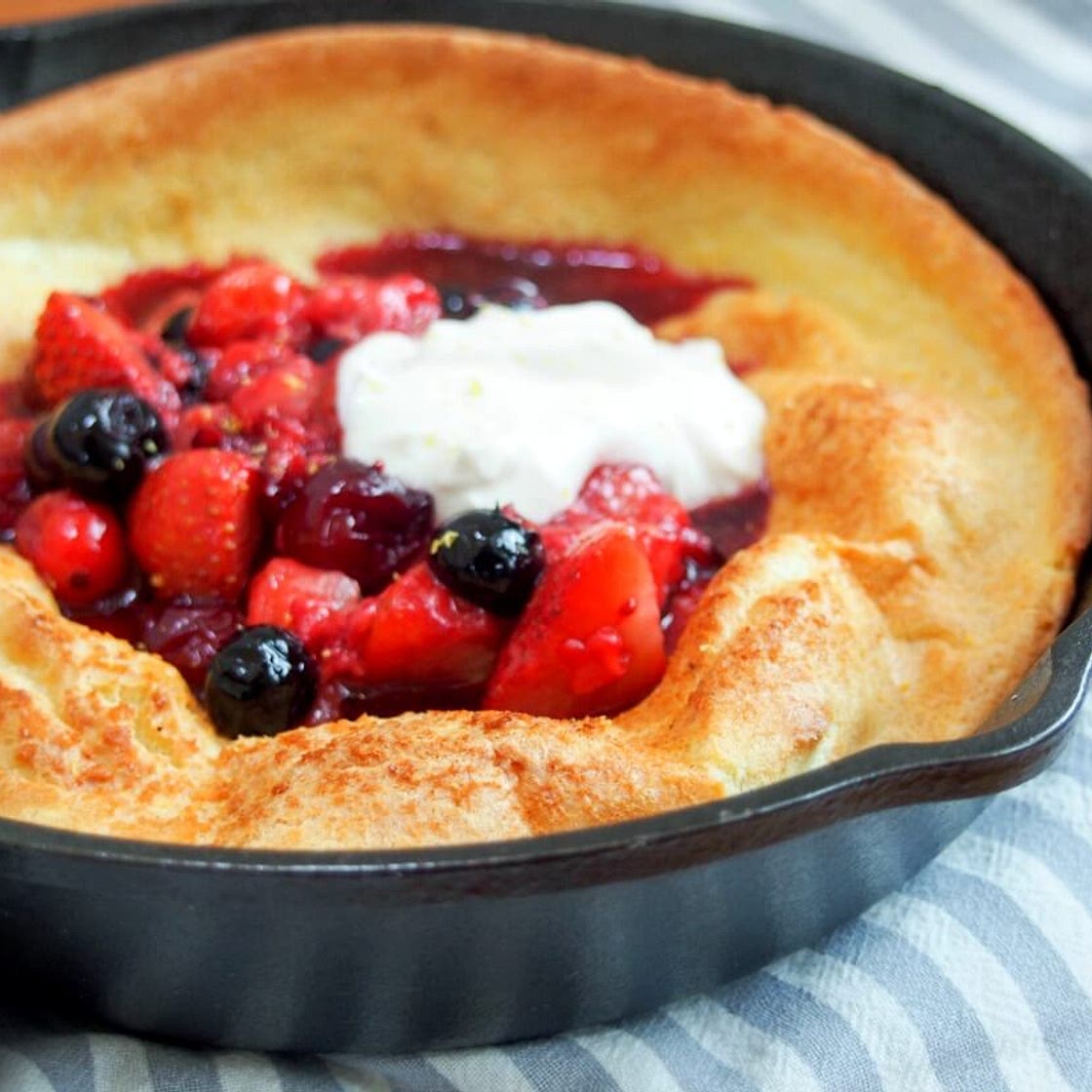 Individual Dutch baby pancake with berries and maple yogurt