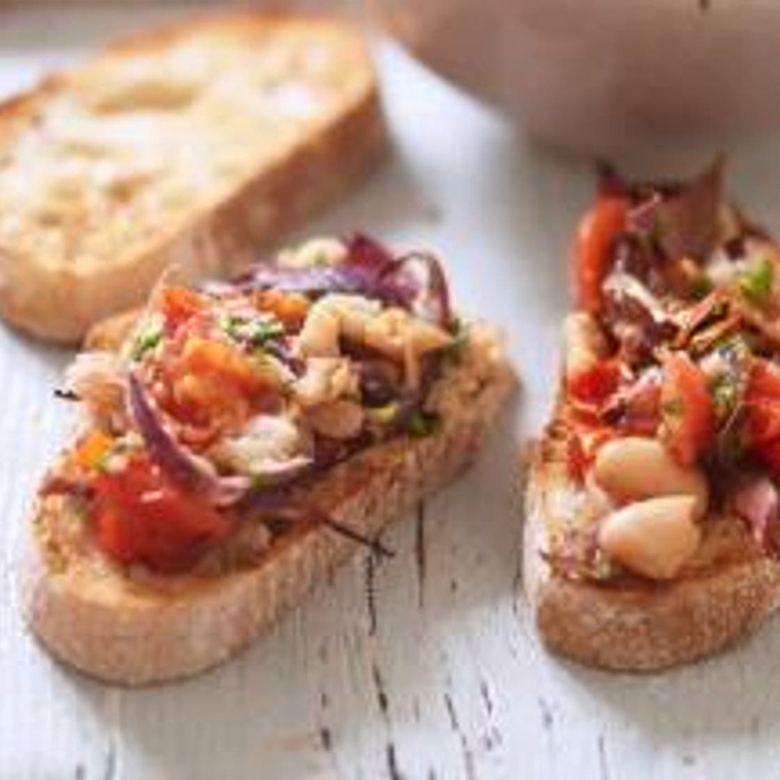Bruschetta with roast tomato red onion and cannellini beans
