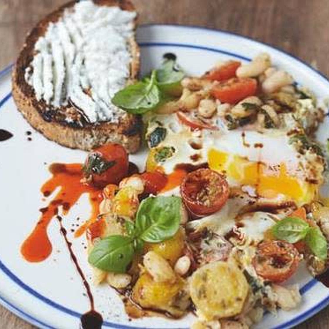 Baked eggs in popped beans  Cherry tomatoes, ricotta on toast