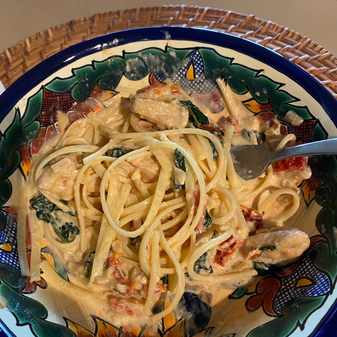 Creamy chicken with sun-dried tomatoes over pasta