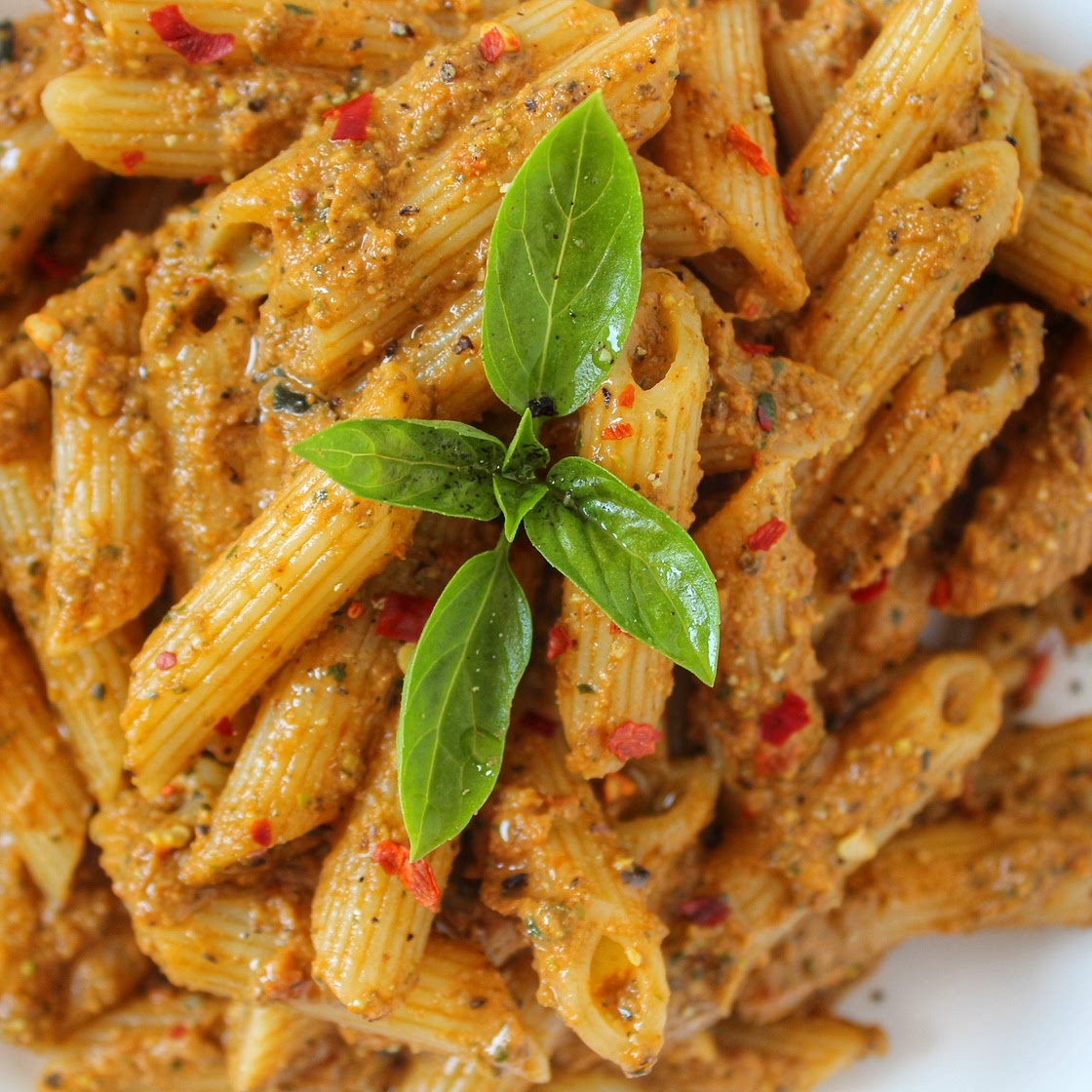 Vegan pasta with olives and tomato pesto.