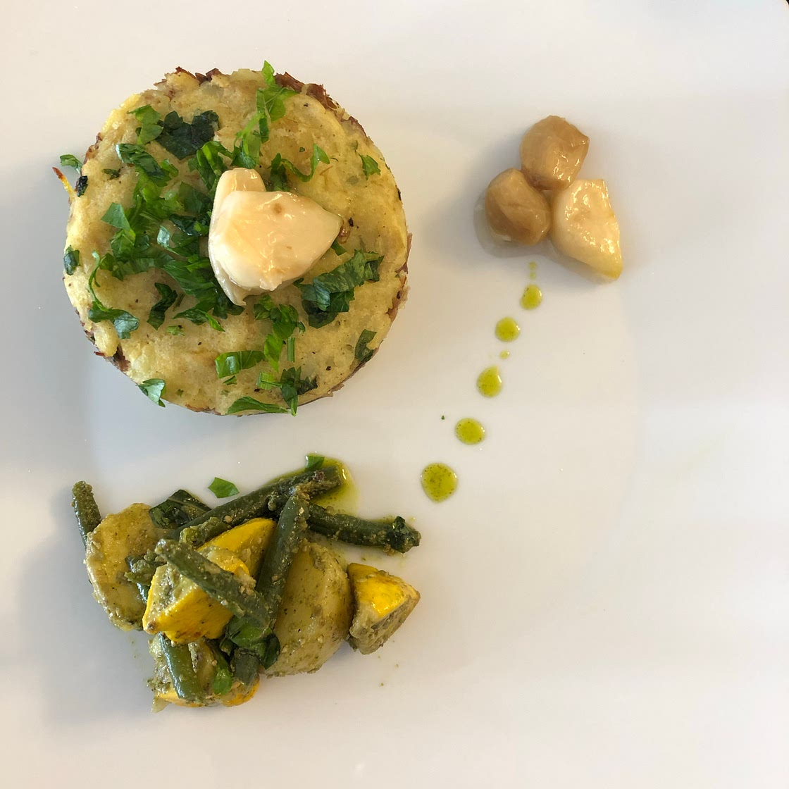 Shredded confit  duck with mashed potato rounds and garlic conf