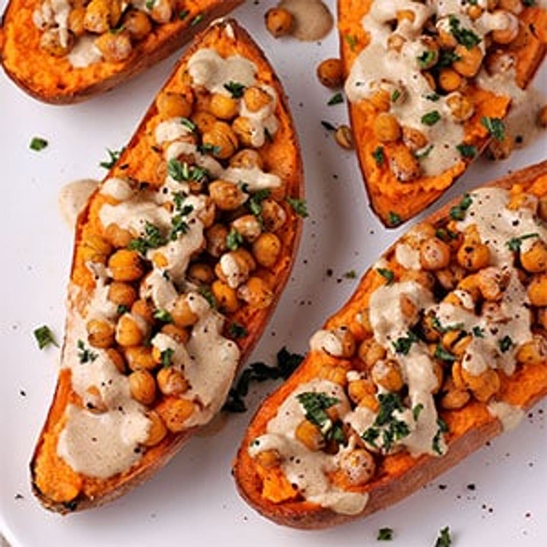 Loaded baked sweet potatoes with lemon-tahini dressing