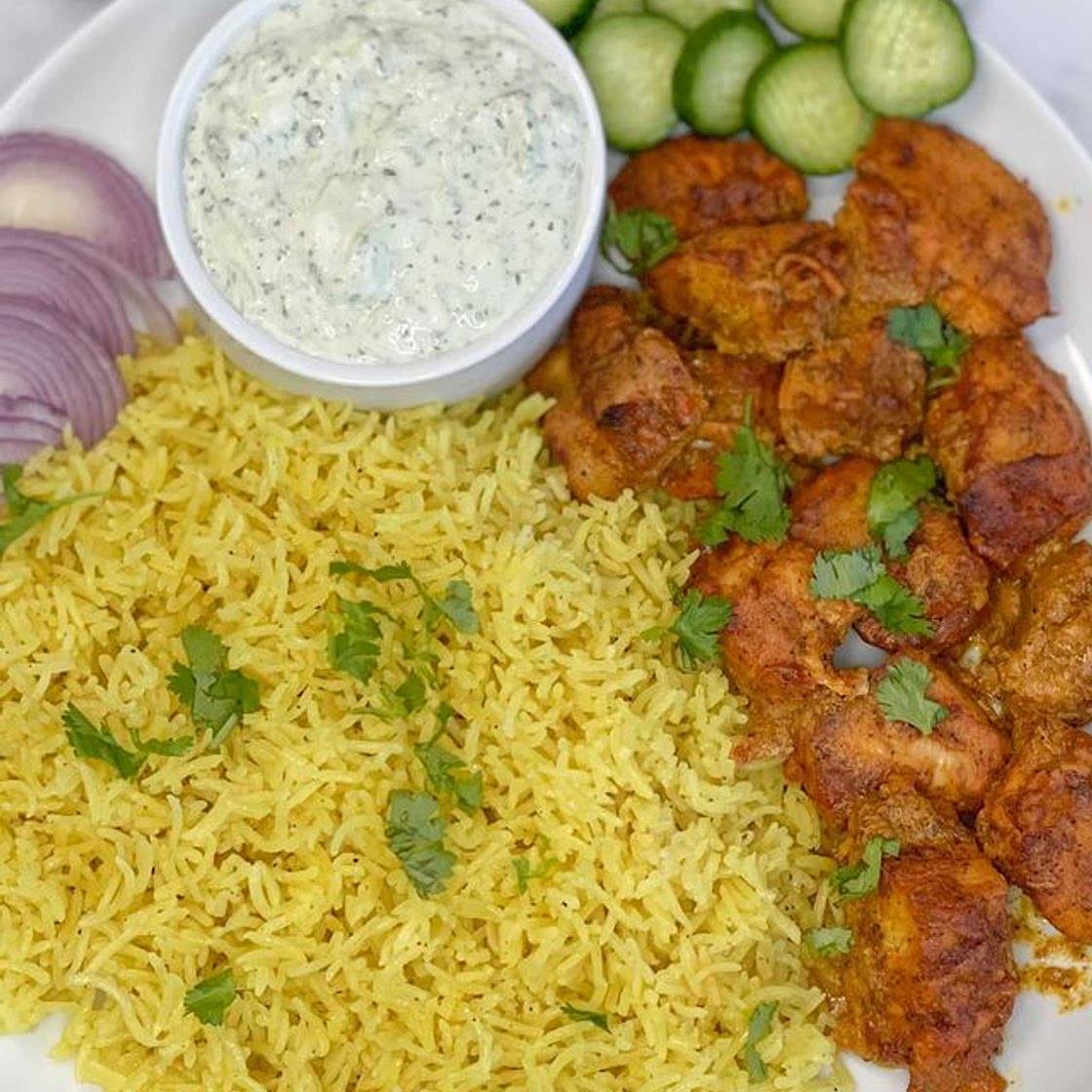 Delicious and super easy tandoori Chicken with yellow rice and a cucumber yogurt sauce, my family’s favorite….. —Tandoori Chicken— : -3 large chicken breasts (cut into 1 inch bite size pieces) -1/4 cup of olive oil -1 tablespoon ginger (fresh or paste) -3