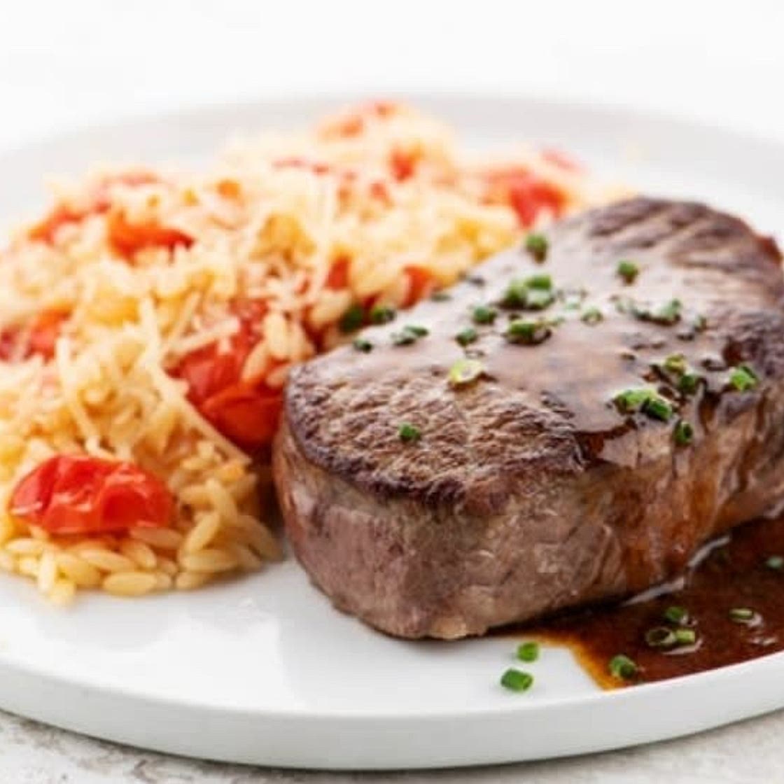 Steak Romano and Garlic-Herb Pan Sauce with tomato and Parmesan orzo