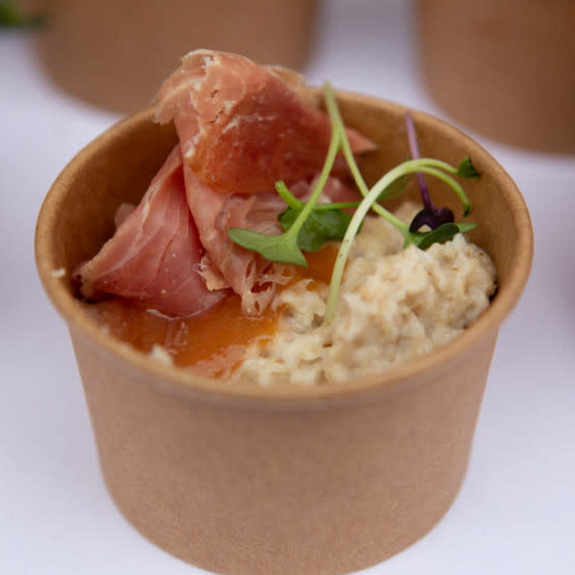 Oatmeal porridge with quince jam and dried ham