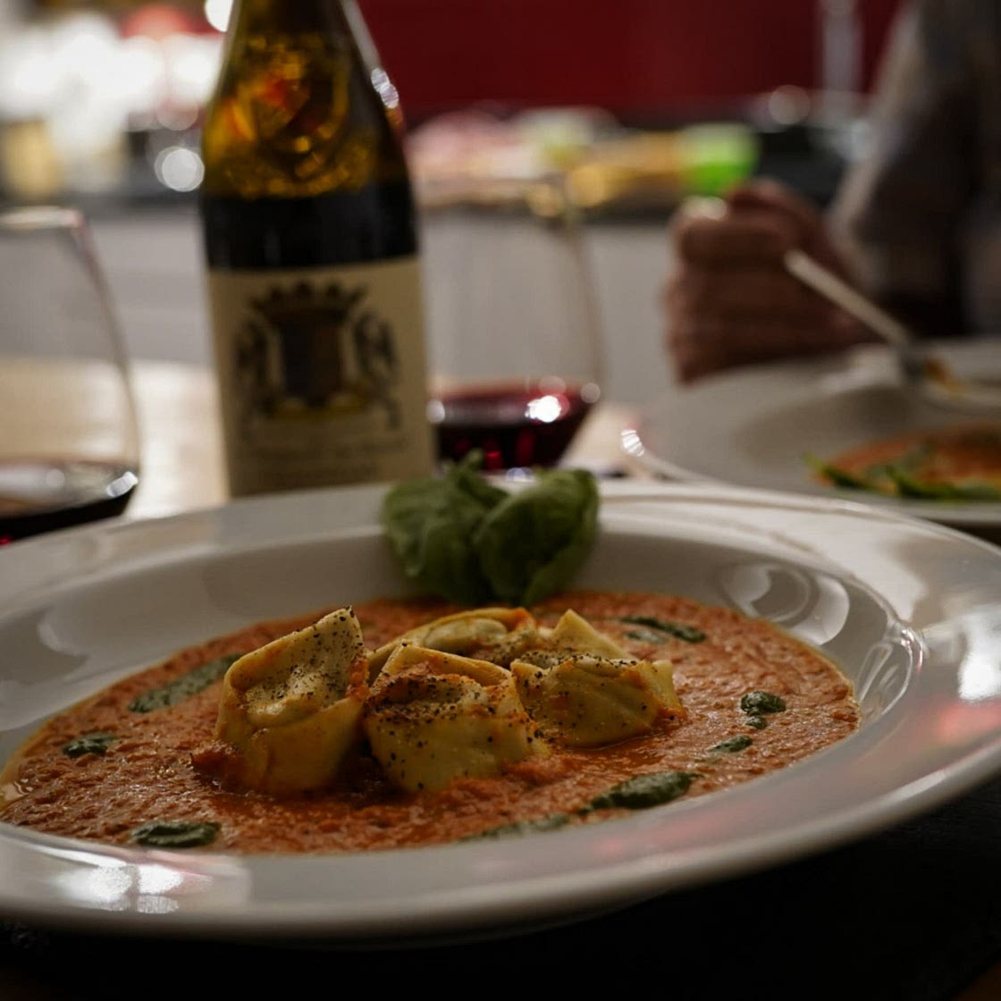 Red pepper broth with tortellini